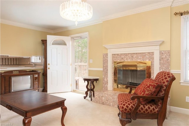 sitting room with an inviting chandelier, ornamental molding, a fireplace, and carpet floors