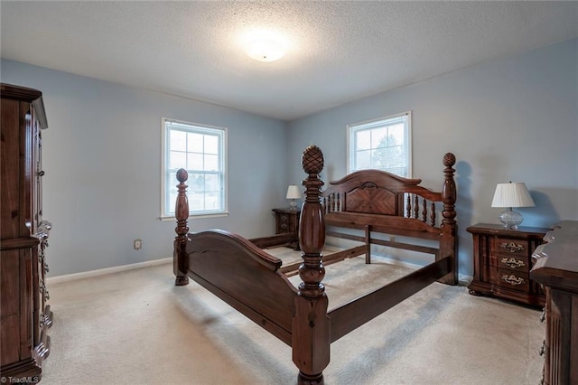 bedroom featuring light carpet and a textured ceiling