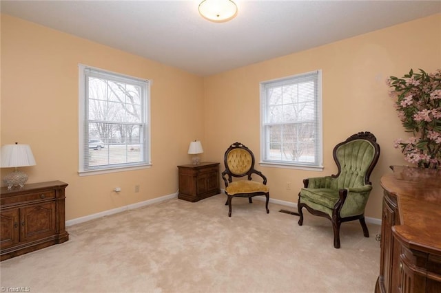 sitting room featuring a healthy amount of sunlight and light carpet