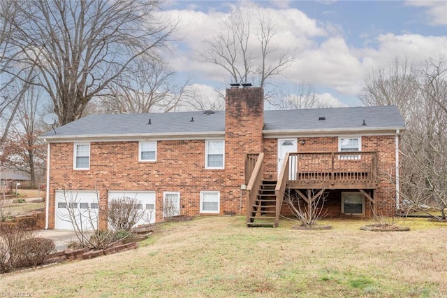 rear view of property featuring a garage, a yard, and a deck