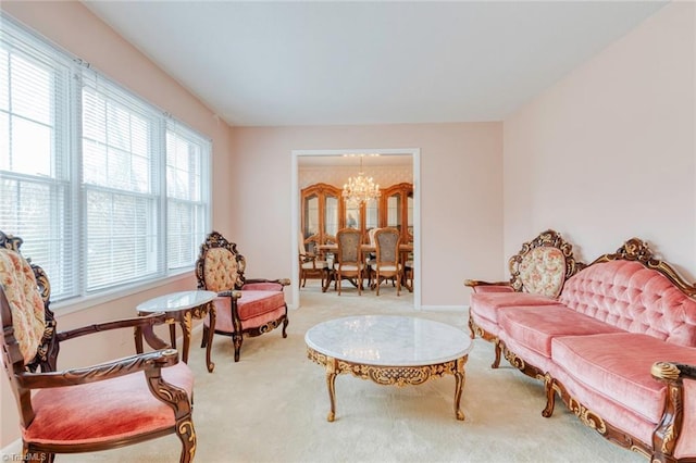 living area featuring a chandelier and carpet