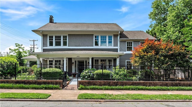 10 W Banner Ave, Winston-Salem, NC 27127 - view of front of property with a fenced front yard, a porch, and a chimney