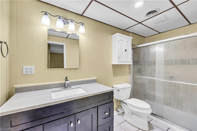 bathroom featuring walk in shower, tile patterned flooring, vanity, and toilet