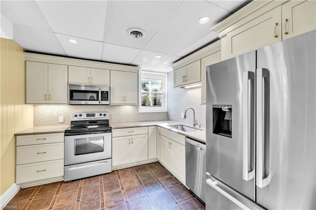 kitchen featuring cream cabinets, sink, and stainless steel appliances