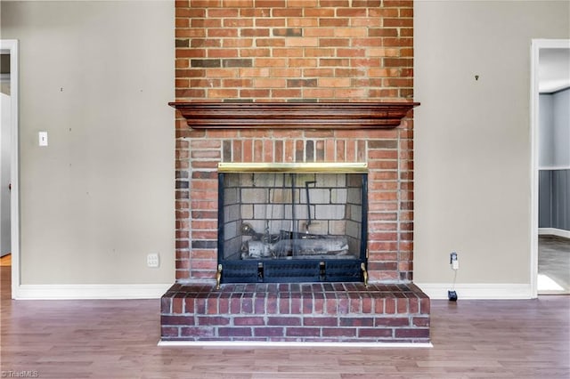 interior details featuring a fireplace and hardwood / wood-style flooring