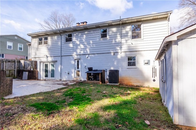 back of property featuring a patio, central AC, and a lawn