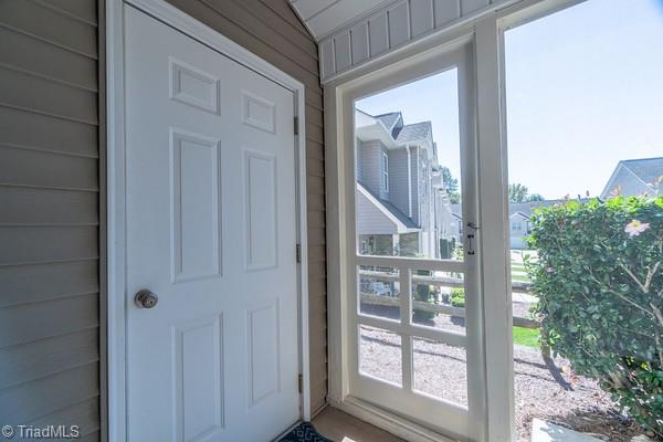 doorway featuring wooden walls