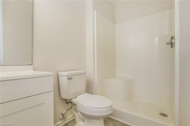 bathroom with vanity, tile patterned floors, a shower, and toilet