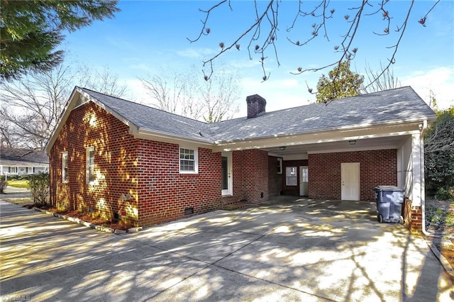 back of house featuring a carport