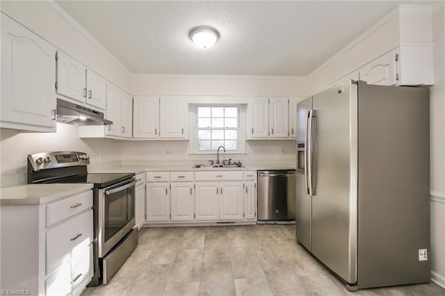 kitchen with sink, appliances with stainless steel finishes, ornamental molding, a textured ceiling, and white cabinets