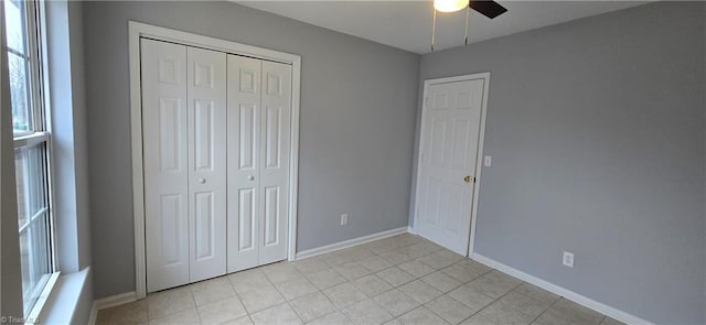 unfurnished bedroom featuring ceiling fan, a closet, and light tile patterned floors