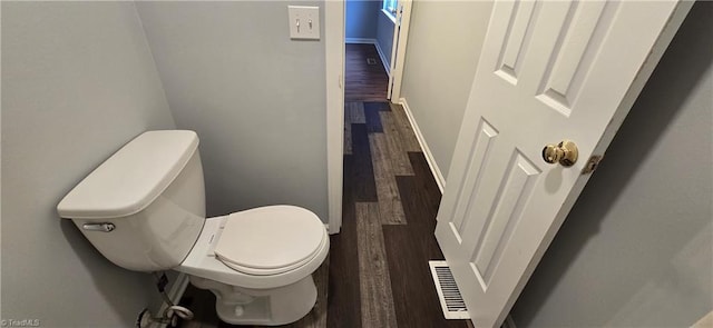 bathroom featuring wood-type flooring and toilet