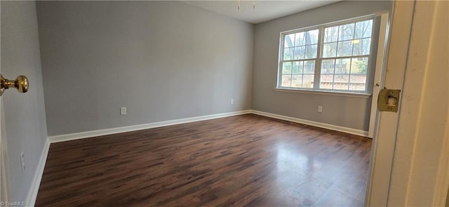 spare room featuring dark hardwood / wood-style floors