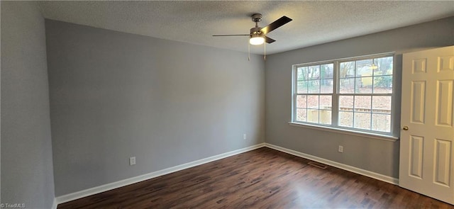 unfurnished room featuring ceiling fan, dark wood-type flooring, and a textured ceiling