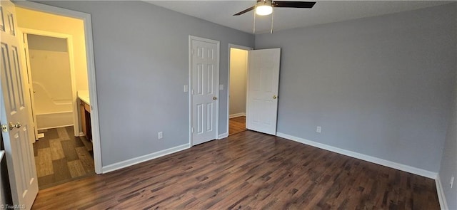 unfurnished bedroom with a closet, dark hardwood / wood-style floors, and ceiling fan