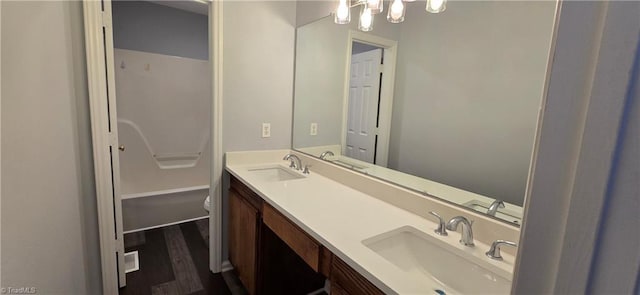 bathroom featuring vanity, hardwood / wood-style floors, and toilet