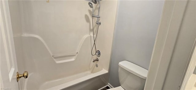 bathroom featuring shower / tub combination and toilet