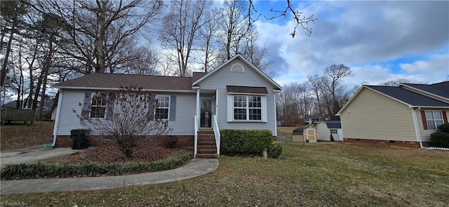 view of front of property featuring a storage unit and a front lawn