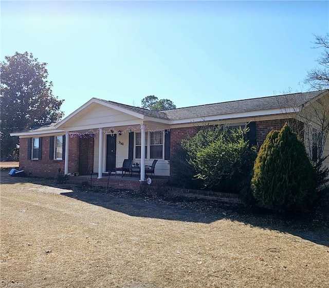 single story home featuring a front yard and covered porch