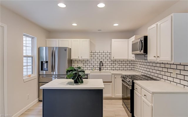 5430 Strasburg Dr, Greensboro, NC 27407 - kitchen featuring stainless steel appliances, a sink, tasteful backsplash, white cabinets, and recessed lighting