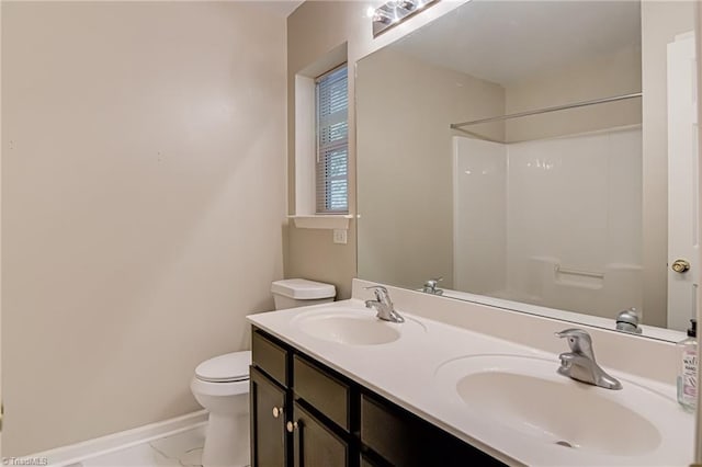 5430 Strasburg Dr, Greensboro, NC 27407 - bathroom featuring toilet, baseboards, marble look tiles, double vanity, and a shower