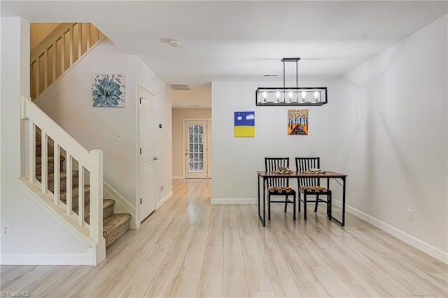 5430 Strasburg Dr, Greensboro, NC 27407 - dining space with stairs, light wood-style floors, and baseboards