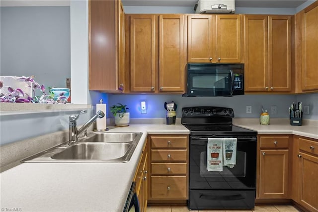 1380 Heritage Pointe Dr Unit 310, Winston-Salem, NC 27127 - kitchen featuring black appliances, light countertops, brown cabinets, and light tile patterned flooring