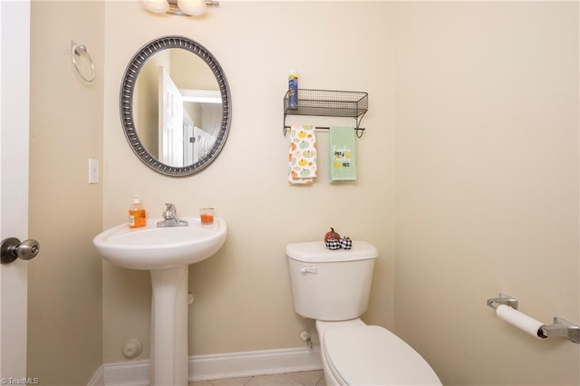 bathroom with tile patterned floors, toilet, and sink