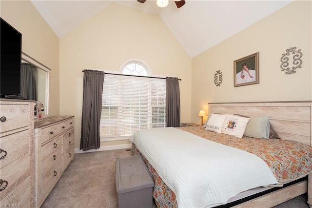 bedroom featuring light colored carpet, vaulted ceiling, and ceiling fan