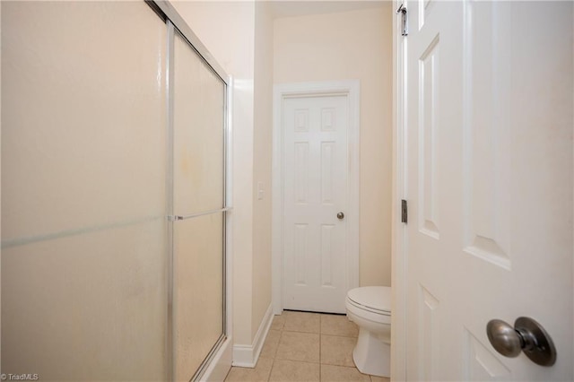 bathroom with toilet, tile patterned floors, and an enclosed shower