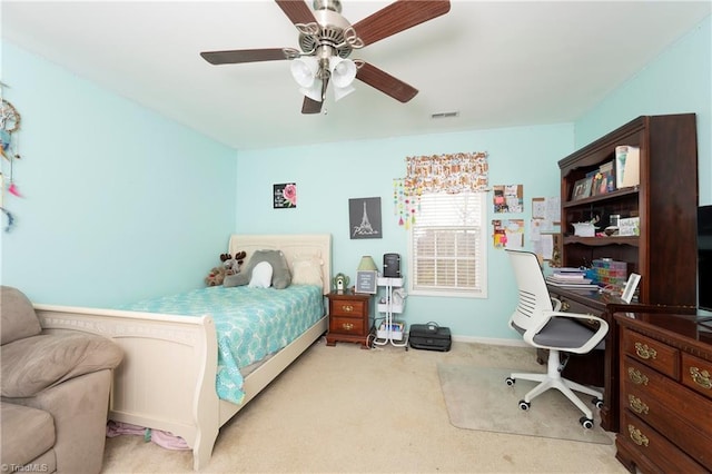 bedroom with ceiling fan and light colored carpet