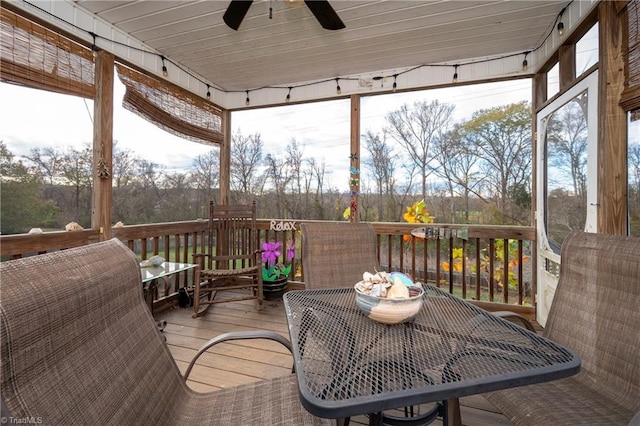 sunroom / solarium featuring ceiling fan and wood ceiling