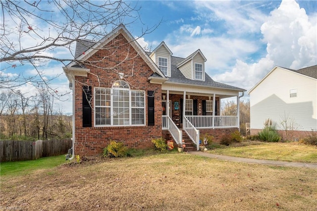 view of front of property featuring covered porch and a front yard