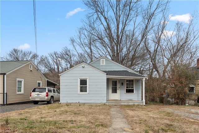 bungalow with a front lawn and a porch