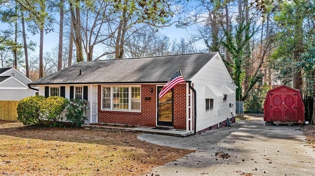 bungalow-style home featuring a storage shed