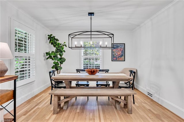 3480 York Rd, Winston-Salem, NC 27104 - dining area featuring light wood-style floors, a chandelier, baseboards, and ornamental molding