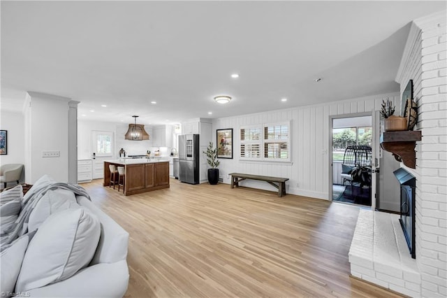 3480 York Rd, Winston-Salem, NC 27104 - living area featuring a brick fireplace, light wood-type flooring, recessed lighting, baseboards, and crown molding