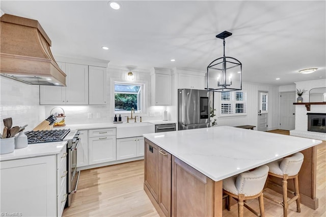 3480 York Rd, Winston-Salem, NC 27104 - kitchen featuring stainless steel appliances, custom range hood, a sink, tasteful backsplash, and a kitchen island