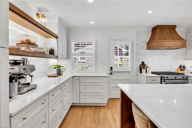 3480 York Rd, Winston-Salem, NC 27104 - kitchen featuring custom exhaust hood, high end range, backsplash, light wood-style floors, and recessed lighting