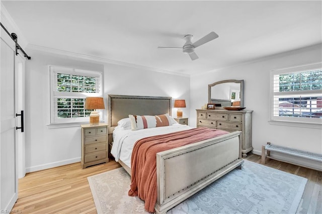 3480 York Rd, Winston-Salem, NC 27104 - bedroom with a barn door, crown molding, light wood finished floors, baseboards, and ceiling fan
