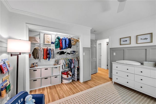 3480 York Rd, Winston-Salem, NC 27104 - bedroom featuring ornamental molding, light wood-style floors, a decorative wall, a wainscoted wall, and a ceiling fan
