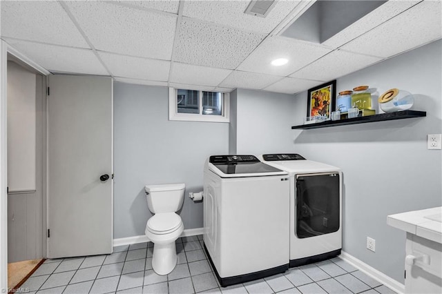 3480 York Rd, Winston-Salem, NC 27104 - laundry room featuring washing machine and clothes dryer, light tile patterned floors, and baseboards
