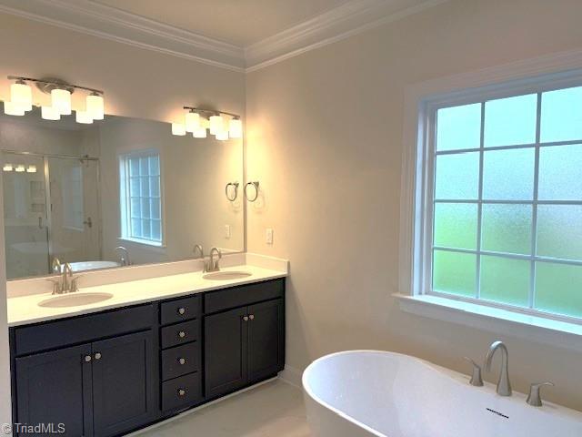 7607 Valhalla Way Lot 20, Greensboro, NC 27409 - full bathroom with a freestanding bath, double vanity, a sink, and a shower stall