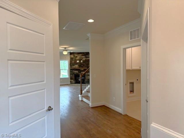 7607 Valhalla Way Lot 20, Greensboro, NC 27409 - hall featuring recessed lighting, crown molding, stairs, visible vents, and wood finished floors