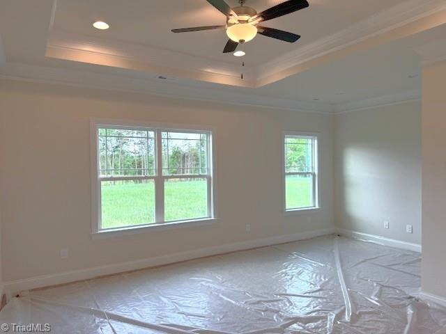 7607 Valhalla Way Lot 20, Greensboro, NC 27409 - empty room featuring recessed lighting, ornamental molding, baseboards, a raised ceiling, and a ceiling fan