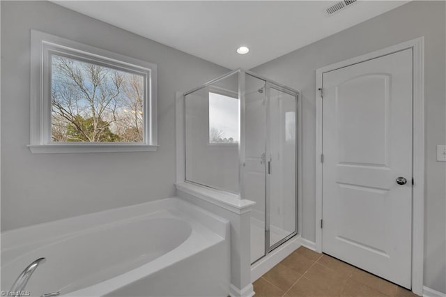 bathroom with separate shower and tub and tile patterned flooring