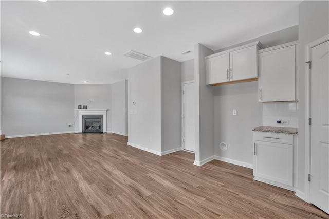 unfurnished living room with light wood-type flooring