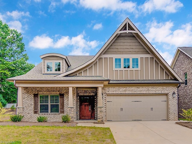 craftsman-style home with a front yard and a garage