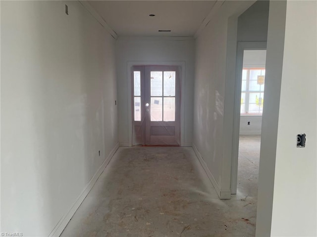 doorway to outside with crown molding