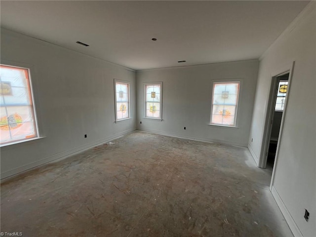 empty room featuring crown molding